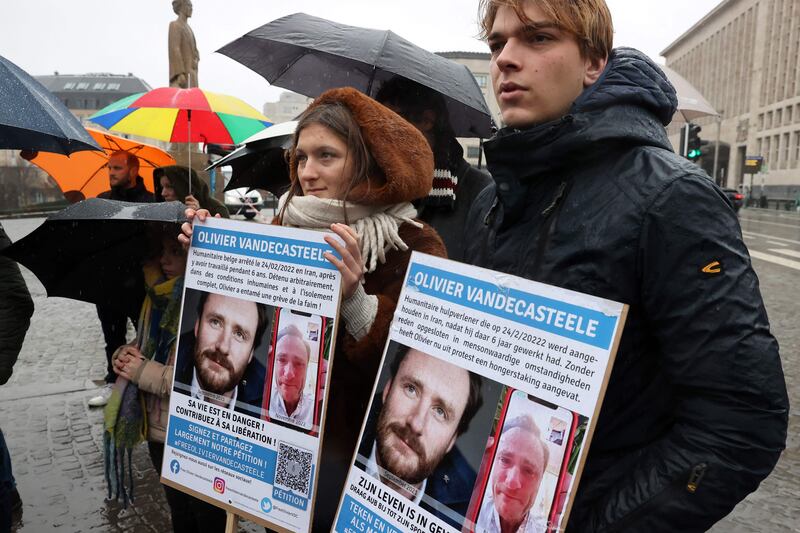 Protesters hold photos of Belgian aid worker Olivier Vandecasteele during a solidarity demonstration in Brussels. AFP