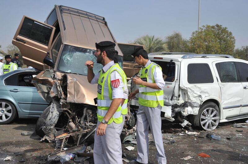 epa02666462 A handout picture released by Emirates News Agency(WAM) shows two UAE policemen at the scene of a road traffic accident involving 127 vehicles on the main road between Abu Dhabi with Dubai, United Arab Emirates on 02 April 2011. An Asian man was killed and nearly 61 people hurt in a pile-up early 02 April 2011 that left wreckage of 127 vehicles scattered near Al Samha area at the highway linking Abu Dhabi with Dubai.The accident is believed to have been caused by a motorist who was driving on high speed in early morning when the highway was enveloped by thick fog. Brigadier Hussein Ahmed Al Harthy, Director of Traffic and Patrols at Abu Dhabi Police said traffic patrols arrived at the scene five minutes after being notified and immediately started to provide an alternative traffic line for ambulances and to remove the vehicles involved in the accident .  EPA/EMIRATES NEWS AGENCY / HANDOUT  EDITORIAL USE ONLY/NO SALES *** Local Caption ***  02666462.jpg