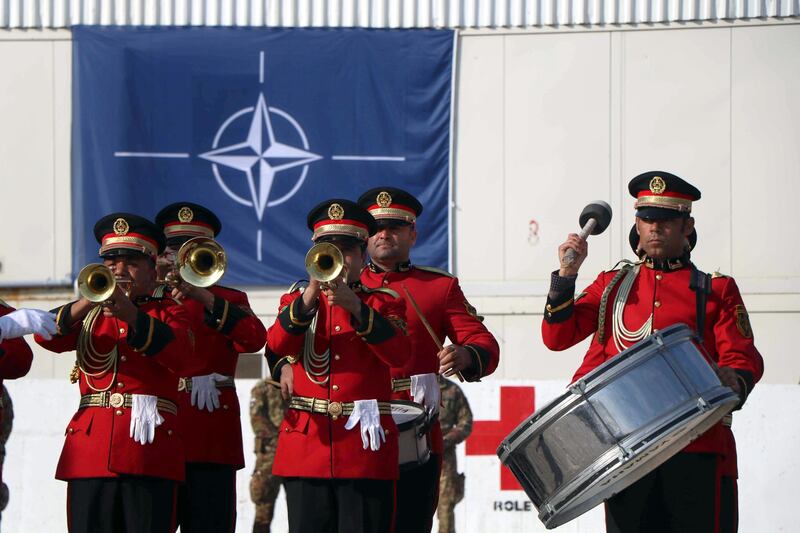 epa08062754 A band performs as Italian soldiers of NATO Resolute Support Mission attend a change of regional command ceremony in Herat, Afghanistan, 11 December 2019. Italian Brigadier General Enrico Bardvani took over the command for the next six months.  EPA/JALIL REZAYEE