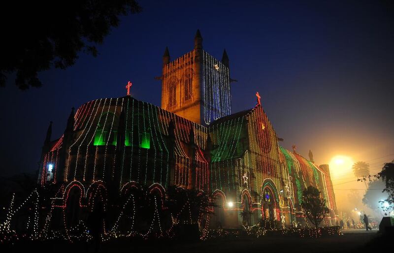 People walk in front of All Saints Cathedral in Allahabad, India.  Saniay Kanoiia / AFP