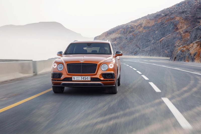 The Bentayga V8 comes with optional 22-inch black wheels and a black grille. Bentley