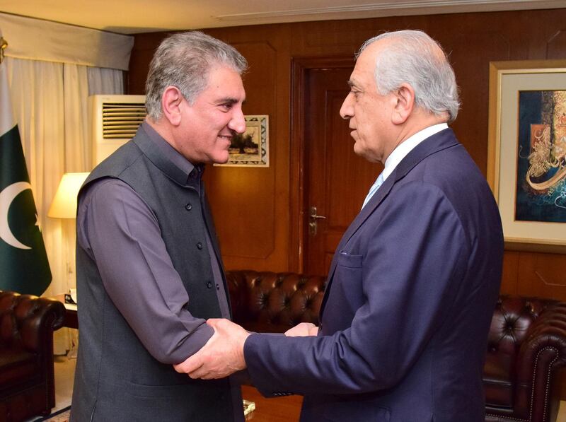 In this photo released by the Foreign Office, Pakistan's Foreign Minister Shah Mehmood Qureshi, left, receives U.S. envoy Zalmay Khalilzad at the Foreign Ministry in Islamabad, Pakistan, Friday, April 5, 2019. Khalilzad has met with Pakistan's foreign minister to find a peaceful solution to neighboring Afghanistan's war. (Pakistan Foreign Office via AP)