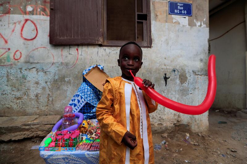 A boy tries to inflate a balloon in Dakar, Senegal. Reuters