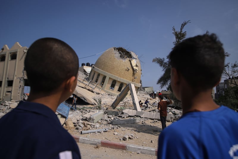 People at the site of a destroyed mosque following an Israeli air strike in Khan Younis, Gaza Strip, on Sunday. Bloomberg