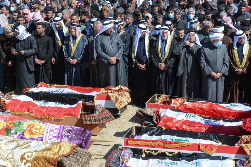 Iraqi mourners pray at the funeral of eight people killed in attacks claimed by ISIS. AFP