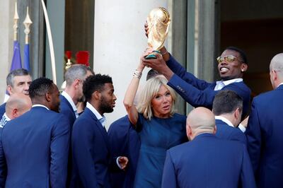 Brigitte Macron, the wife of French President Emmanuel Macron (not pictured), and player Paul Pogba hold the trophy before a reception to honour the France soccer team after their victory in the 2018 Russia Soccer World Cup, at the Elysee Palace in Paris, France, July 16, 2018.   REUTERS/Philippe Wojazer