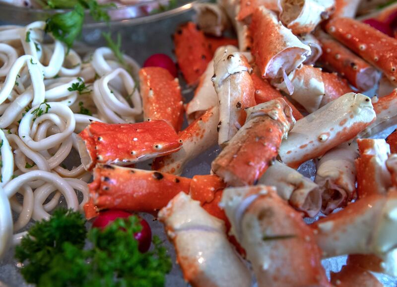 A seafood bar features calamari, crab, oysters and the like