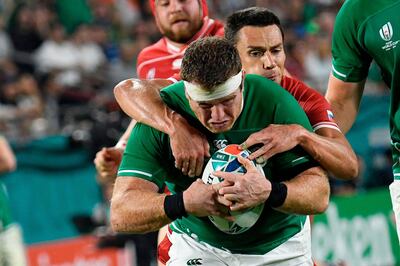 TOPSHOT - Ireland's hooker Sean Cronin (L) is tackled by Russia's scrum-half Dmitry Perov  during the Japan 2019 Rugby World Cup Pool A match between Ireland and Russia at the Kobe Misaki Stadium in Kobe on October 3, 2019. / AFP / Filippo MONTEFORTE
