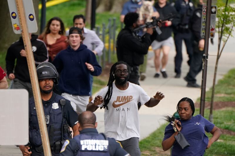 DC Metropolitan Police evacuate people near the scene of a shooting on Friday, April 22, in an upscale neighbourhood in north-west Washington. AP