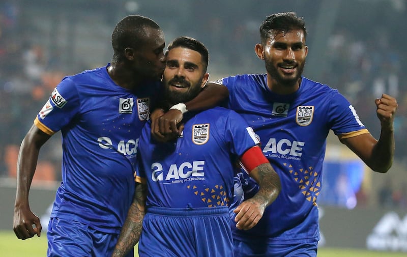 Paulo Machado, center, of Mumbai City FC is greeted by his team players after scoring a goal against Bengaluru FC during the Hero Indian Super League (ISL) soccer match in Mumbai, India, Sunday, Jan. 27, 2019.(AP Photo/Rafiq Maqbool)