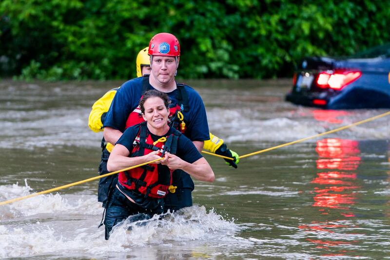 Commuters are rescued from a flooded car on Columbia Pike after a flash flood in Oakland Mills, Maryland, USA, 27 May 2018. The National Weather Service stated as much as 9.5 inches of rain fell in the area.  Jim Lo Scalzo / EPA