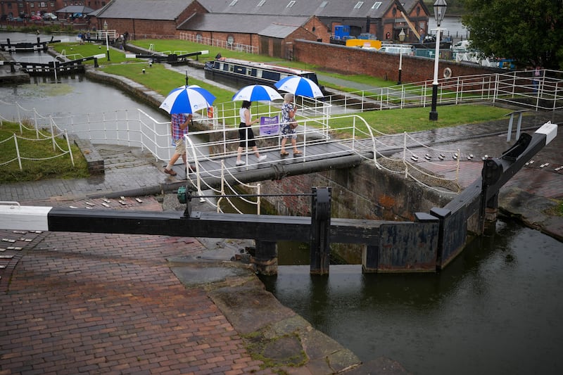 Visitors to the National Waterways Museum use umbrellas during a spell of rain in Ellesmere Port. Getty Images