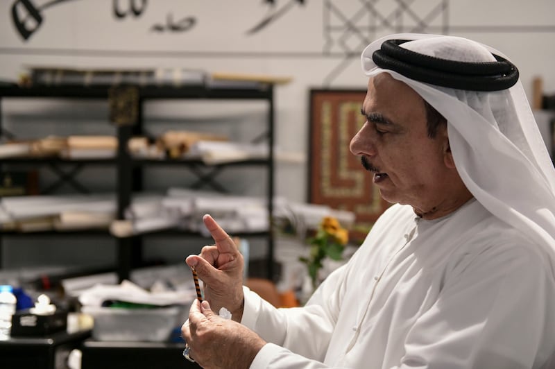 Mandi shaves wood for calligraphy design at the Cultural Foundation in Abu Dhabi
