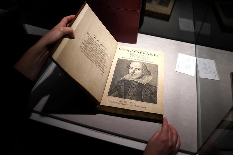 An employee of Christie's holds a 1623 rare first folio of 36 Shakespeare works that was sold for a record $9.97 million on October 14. Reuters