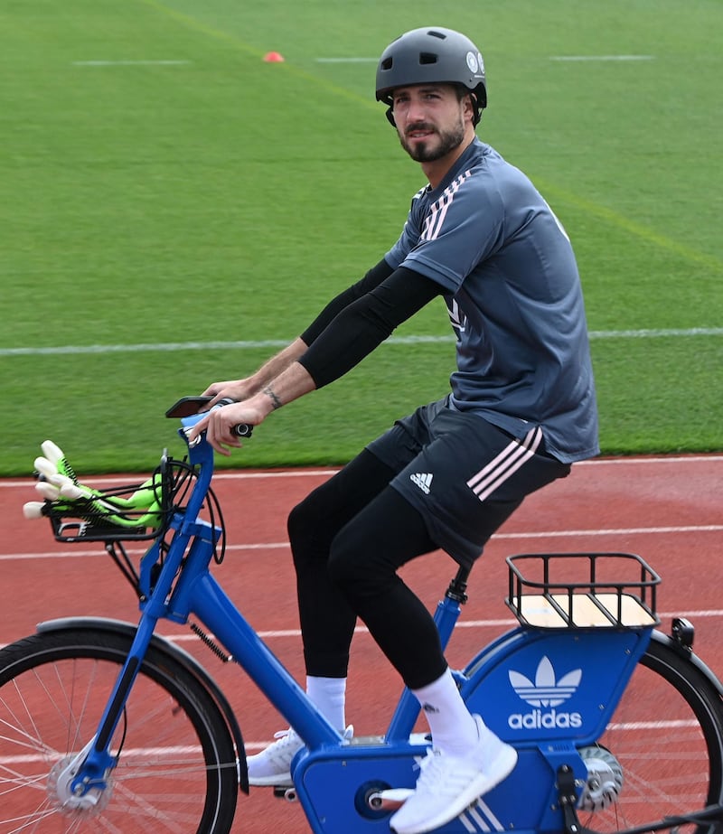 Germany goalkeeper Kevin Trapp arrives on a bicycle . AFP