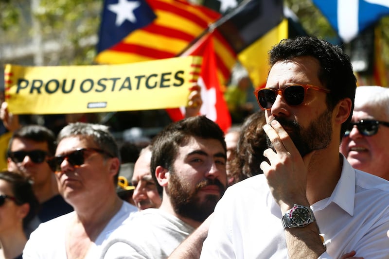 Catalan parliament speaker Roger Torrent, right, takes part in the demonstration, which was called by the Catalan platform Espai Democracia i Convivencia. EPA/Quique Garcia