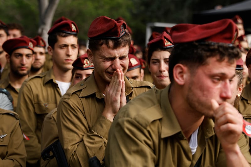 Israeli soldiers mourn Sgt David Sassoon at a funeral in Netanya. Sgt Sassoon was one of more than 245 Israeli troops killed in the Gaza war. Getty Images