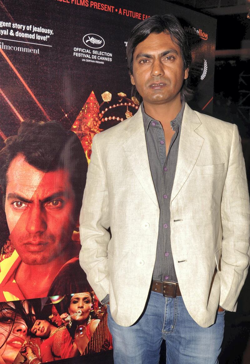 Indian Bollywood actor Nawazuddin Siddiqui poses during the first look of upcoming Hindi film "Miss Lovely" in Mumbai on December 23, 2013. AFP PHOTO/STR (Photo by STRDEL / AFP)