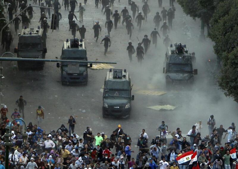 Protesters run from riot police during clashes at Tahrir square in Cairo on November 23, 2012. Egyptian President Mohammed Morsi's decree that put his decisions above legal challenge until a new parliament was elected caused fury amongst his opponents who accused him of being the new Hosni Mubarak and hijacking the revolution. Mohamed Abd El Ghany / Reuters