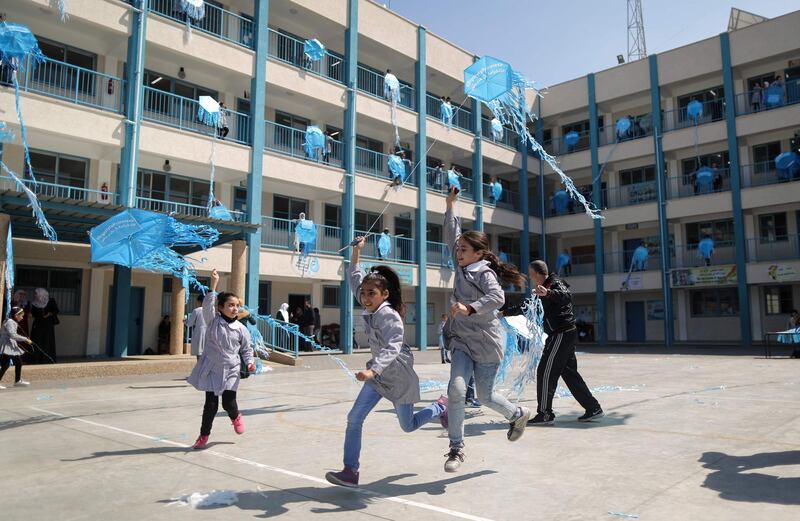 Palestinian schoolgirls fly kites outside their classrooms at a school belonging to the United Nations Relief and Works Agency for Palestinian Refugees (UNRWA) in Gaza City on March 12, 2018 as a protest against US aid cuts.
On January 16, Washington held back $65 million that had been earmarked for the UN Relief and Works Agency for Palestinian refugees (UNRWA), but the State Department denied the freeze was to punish the Palestinian leadership, which has cut ties with President Donald Trump's administration following his recognition of Jerusalem as Israel's capital last year, with a spokeswoman saying it was linked to necessary "reform" of UNRWA. / AFP PHOTO / MAHMUD HAMS