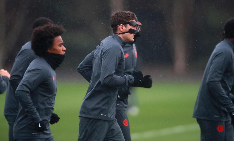 Chelsea's Christian Pulisic (centre) warms up with a mask on during a training session ahead of their Champions Lague game against Bayern Munich. PA