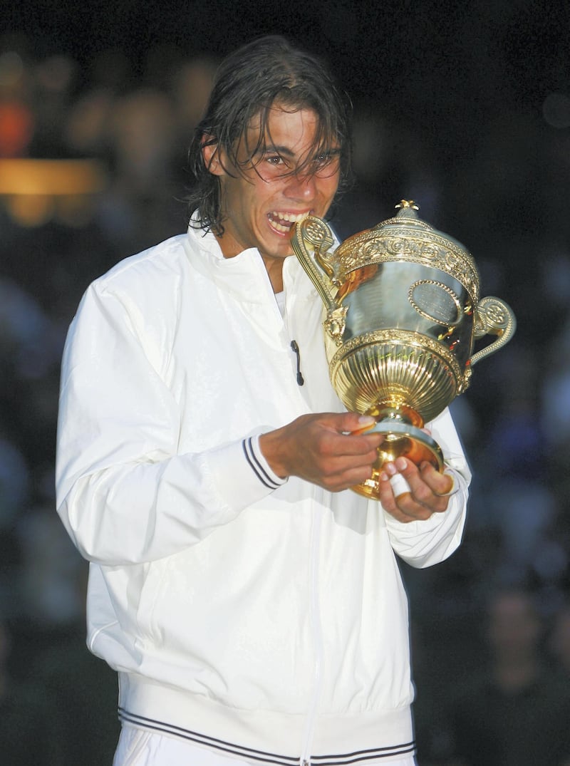LONDON - JULY 06:  Rafael Nadal of Spain celebrates with the trophy winning the Championship during the men's singles Final match against Roger Federer of Switzerland on day thirteen of the Wimbledon Lawn Tennis Championships at the All England Lawn Tennis and Croquet Club on July 6, 2008 in London, England.  (Photo by Clive Brunskill/Getty Images)
