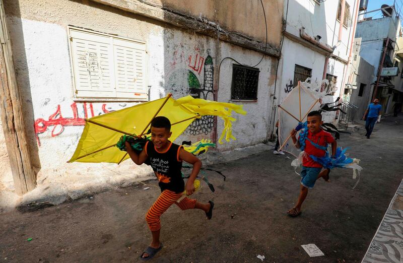 Palestinian children play in a street in the Amari refugee camp near the West Bank city of Ramallah.  AFP