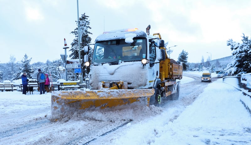 A snow plough clears a road in Carrbridge, Scotland. Reuters