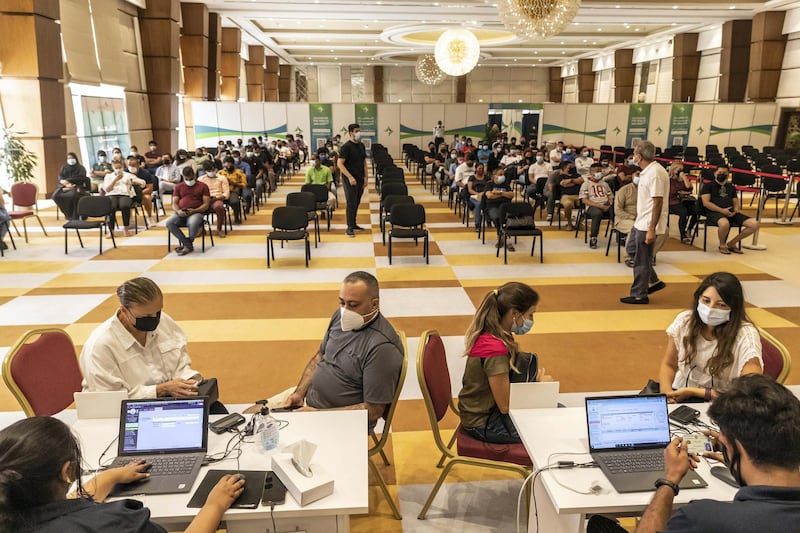 Members of the public with appointments wait to be registered before being vaccinated at newly opened Al Barsha Hall, Vaccination Centre that are administering 4000 vaccinations a day on May 5th, 2021