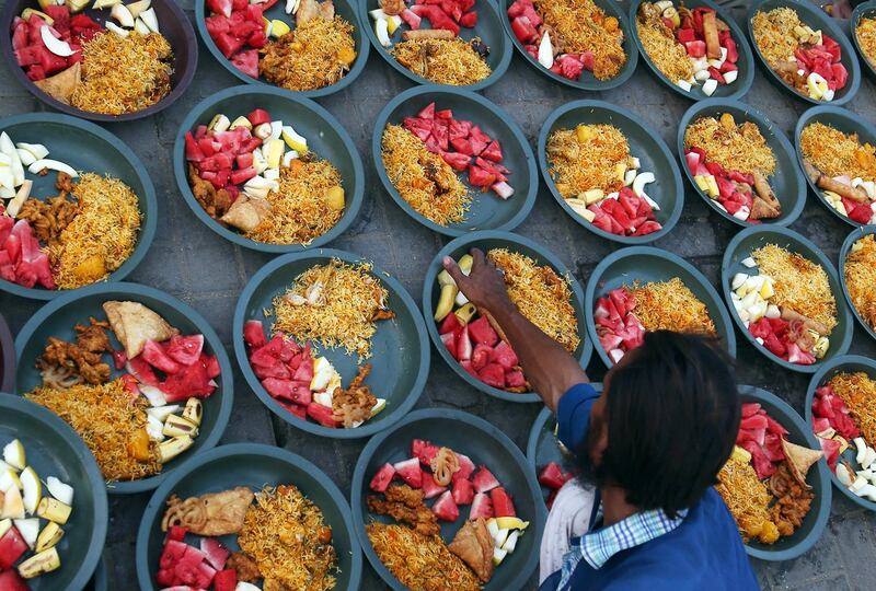 epa06748106 People offer free meals to break the Fast on a road side during the holy Fasting month of Ramadan, in Karahi, Pakistan, 18 May 2018. Muslims around the world celebrate the holy month of Ramadan by praying during the night time and abstaining from eating, drinking, and sexual acts during the period between sunrise and sunset. Ramadan is the ninth month in the Islamic calendar and it is believed that the revelation of the first verse in Koran was during its last 10 nights.  EPA/REHAN KHAN