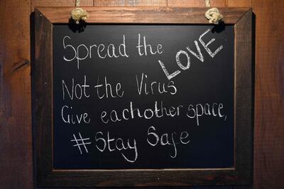 A safety message is posted on a board at the The Shy Horse pub and restaurant in Chessington, Greater London on July 4, 2020, on the first day of a major relaxation of lockdown restrictions during the novel coronavirus COVID-19 pandemic. Pubs and restaurants reopen as part of a wider government plan to relaunch the hospitality, tourism and culture sectors and help the UK economy recover from more than three tough months of lockdown. / AFP / Ben STANSALL

