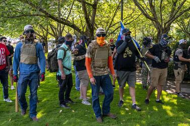 Proud Boys and other right-wing demonstrators pursue counter-protesters after a pro-Trump caravan rally at the Oregon State Capitol building on September 7, 2020. Getty Images / AFP