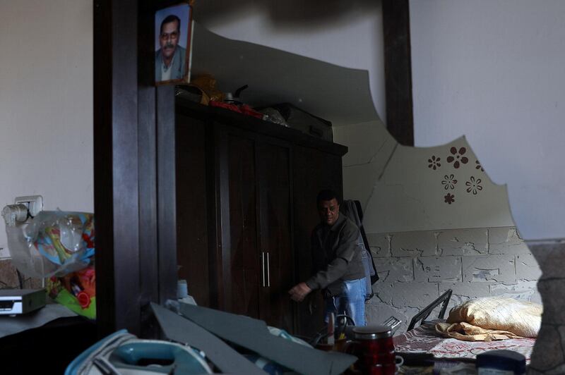A resident is seen reflected in a mirror inside his damaged house in Gaza City. Reuters