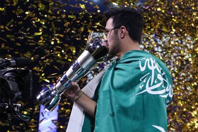 Saudi Arabia’s Mosaad "Msdossary" Aldossary holds aloft the 2018 eFIFA World Cup trophy. Credit: James Townley