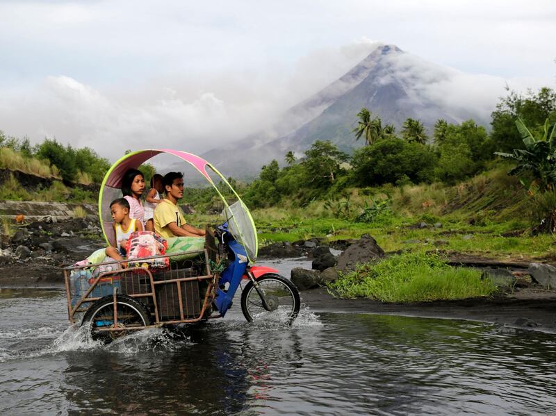 Filipino villagers with their belongings manoeuvre along the slopes of rumbling Mayon Volcano in Legaspi city, Albay province, Philippines. Francis R. Malasig / EPA