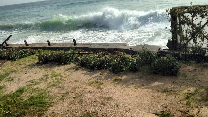 Waves broke the hotel's wooden railing and swept the debris away