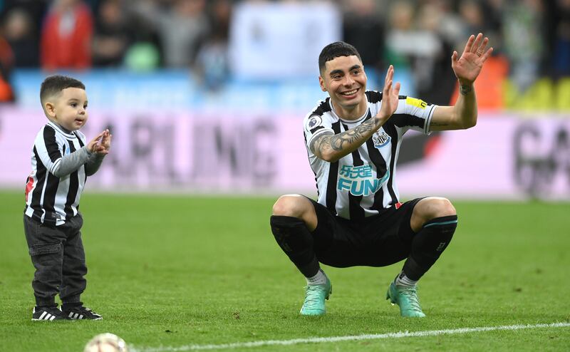 Newcastle player Miguel Almiron plays with his child on the pitch after the Premier League match. Getty Images
