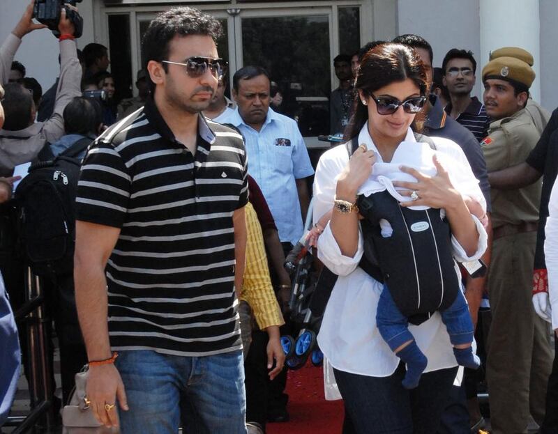 Shilpa Shetty, right, with her baby and husband, Raj Kundra; they own a flat in the Burj Khalifa. AFP