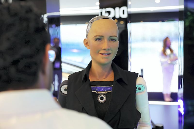 DUBAI , UNITED ARAB EMIRATES , OCT 10   – 2017 :- Visitors talking to social robot called ‘Sophia’ which is on display at the Etisalat stand during the GITEX Technology Week held at Dubai World Trade Centre in Dubai. (Pawan Singh / The National ) Story by Nicholas Webster 