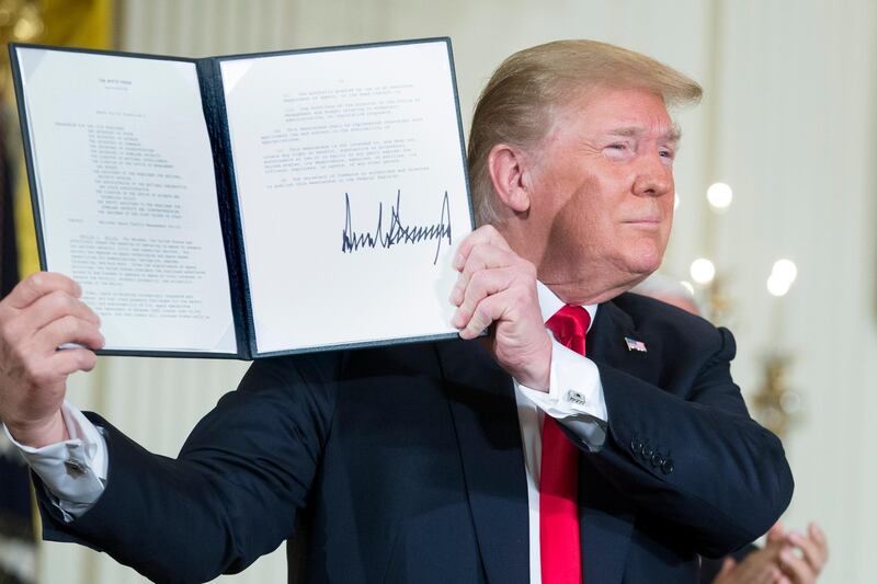 epa06819547 US President Donald J. Trump holds up a Space policy directive he just signed during a meeting of the National Space Council in the East Room of the White House in Washington, DC, USA, 18 June 2018. Trump used the event as an opportunity to deliver remarks on immigration, labeling Democrats as 'obstructionists' and blamed them for children being separated from their parents at the border - a policy of the Trump administration that has faced widespread, bipartisan criticism.  EPA/MICHAEL REYNOLDS