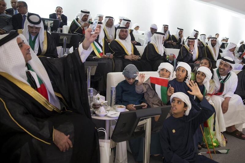 Lt Gen Sheikh Saif bin Zayed, Deputy Prime Minister and Minister of Interior (L) takes a photo of Sheikh Abdullah bin Zayed, Minister of Foreign Affairs (R) and children attending the 44th UAE National Day celebrations at Zayed Sports City. Mohamed Al Hammadi / Crown Prince Court - Abu Dhabi