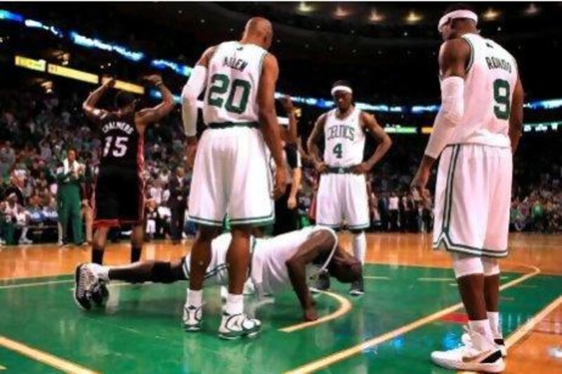 As his Boston Celtics teammates look on Kevin Garnett does pushups after being knocked down by the Miami Heat's Udonis Haslem in the first half.