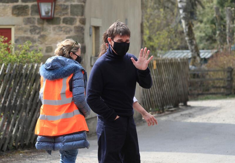 Tom Cruise walks to the set of his latest project.  Danny Lawson / PA via AP