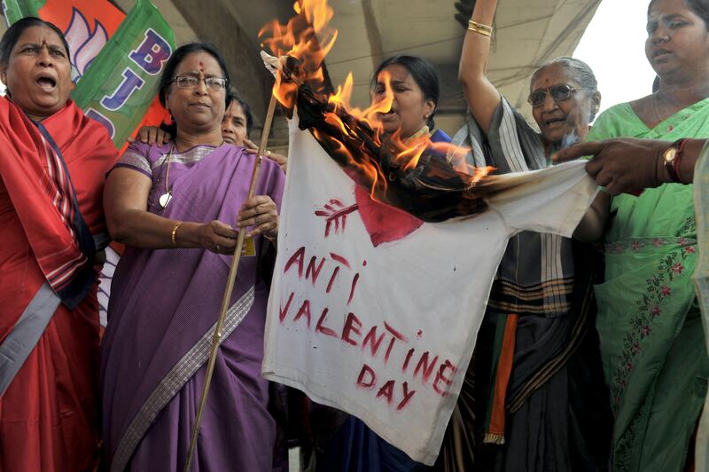 Indian women members of right-wing Bharatiya Janatha Party (BJP) set fire to an effigy representing Valentine's day during a protest to denounce Valentine's Day in Hyderabad on February 14, 2012. The BJP and right-wing hindu groups strongly oppose Valentine's day celebrations citing them as cultural invasion on the Hindu way of life. AFP PHOTO / Noah SEELAM
 *** Local Caption ***  864823-01-08.jpg
