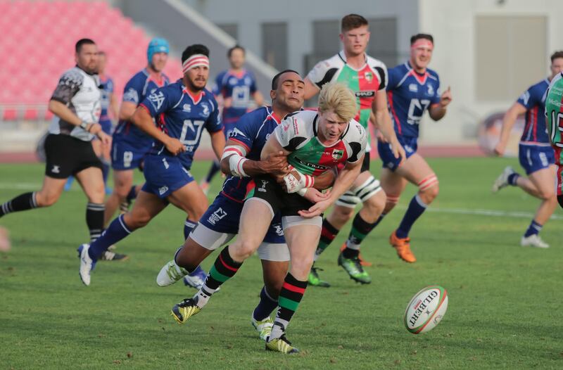 Dubai,UAE, April 7, 2017,  Abu Dhabi Harlequins (red and green) VS. Jebel Ali Dragons (Blue) Premiership final. (L-R)  Andrew Semple (R) gets tackled bySaki Naisau.
Victor Besa for The National
ID: 38294
Reporter:  Paul Radley
Sports *** Local Caption ***  VB_040717_sp-rugby-3.jpg