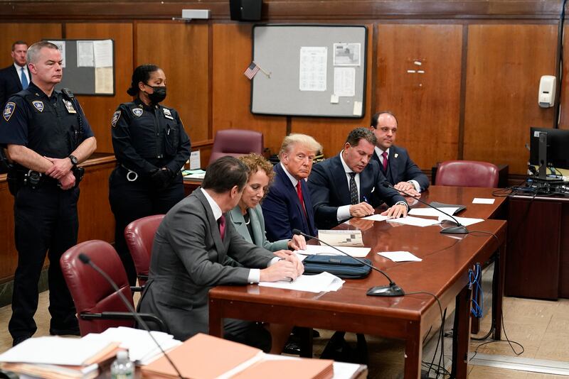 Mr Trump at the defence table with his team of lawyers. AP