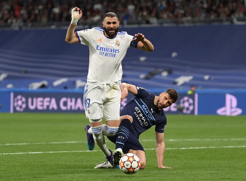 Benzema is fouled by Ruben Dias leading to the decisive penalty. Getty