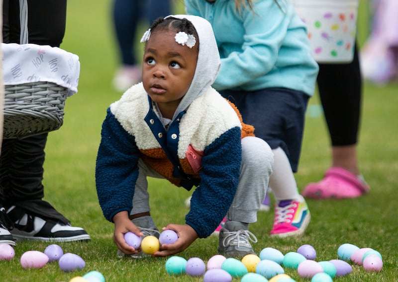 A child collects Easter eggs during an event to mark the Christian festival in the US city of Kentucky. AP