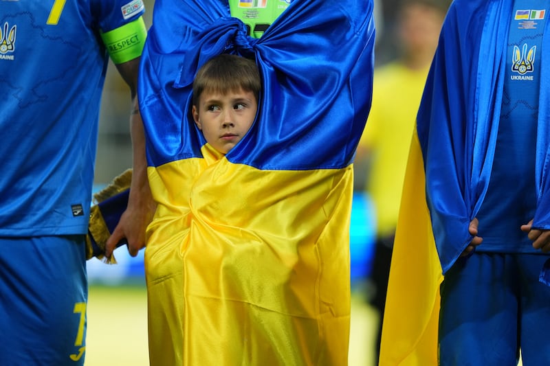 A mascot is wrapped in the colours of the Ukrainian flag before the country's Uefa Nations League football match against the Republic of Ireland in Lodz, Poland. Reuters