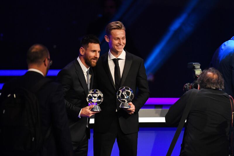 Barcelona's Messi and De Jong with their respective trophies. EPA